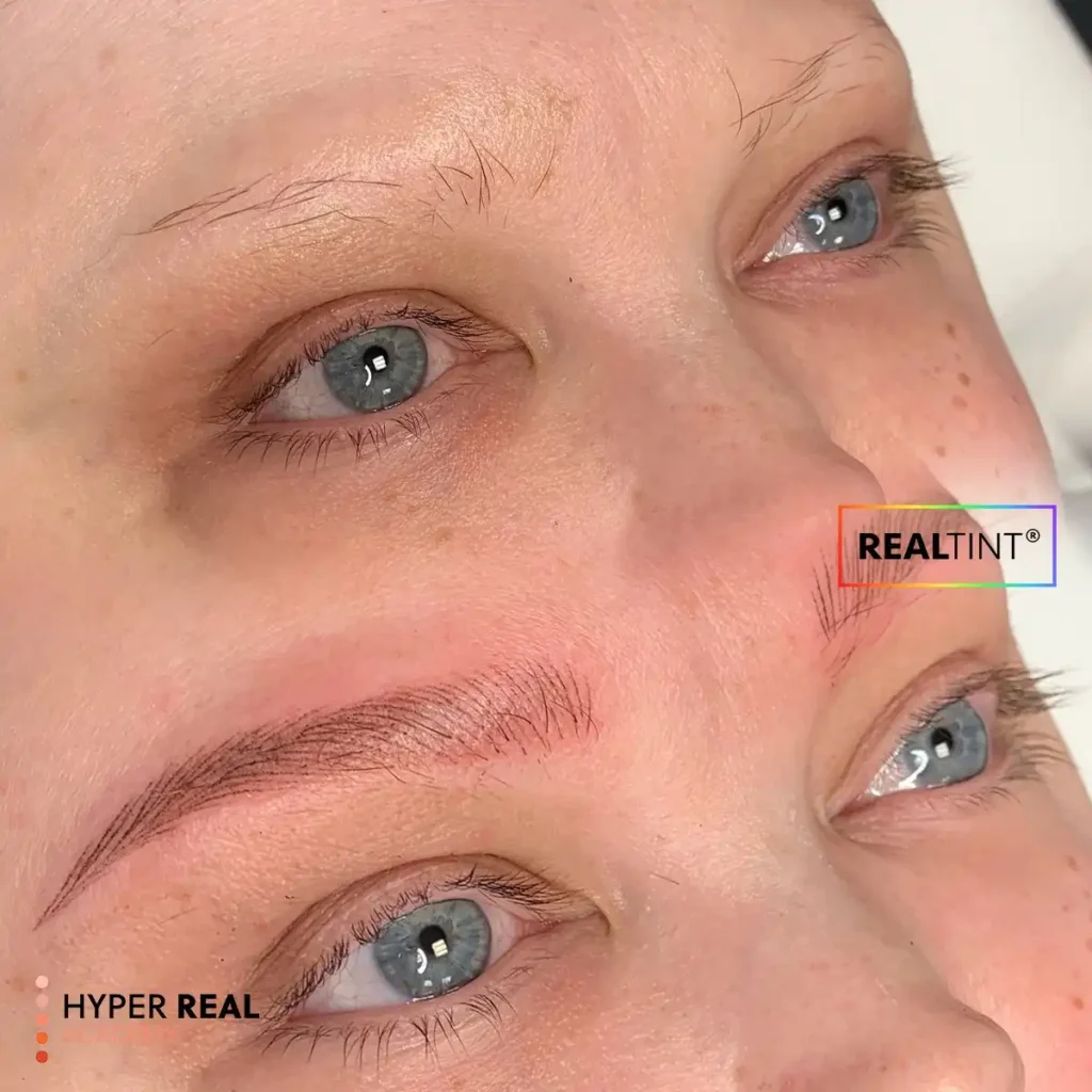 Close-up nano brows PMU result with ultra-fine hair-like strokes and natural brown pigment. RealTint® and Hyper Real Academy branding for permanent makeup.
