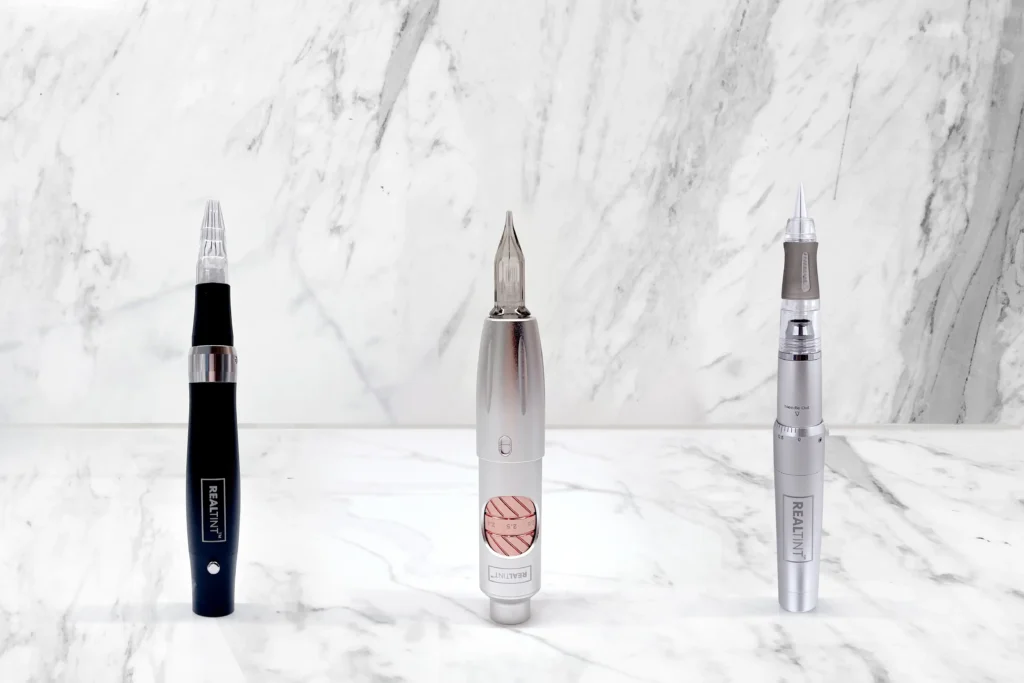 PMU rotary machines on marble surface. Professional permanent makeup equipment for microblading, lip blush, eyeliner, and SMP procedures.