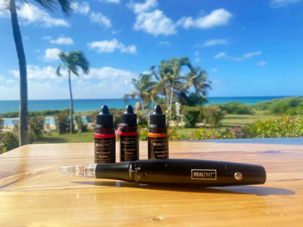 PMU machine and supplies with tropical background. Promotional photo from RealTint® training workshop.