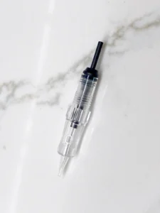 Polaris PMU needle cartridge on marble. Hyper Real Academy training demonstration for nano brows, hair strokes, and eyeliner.