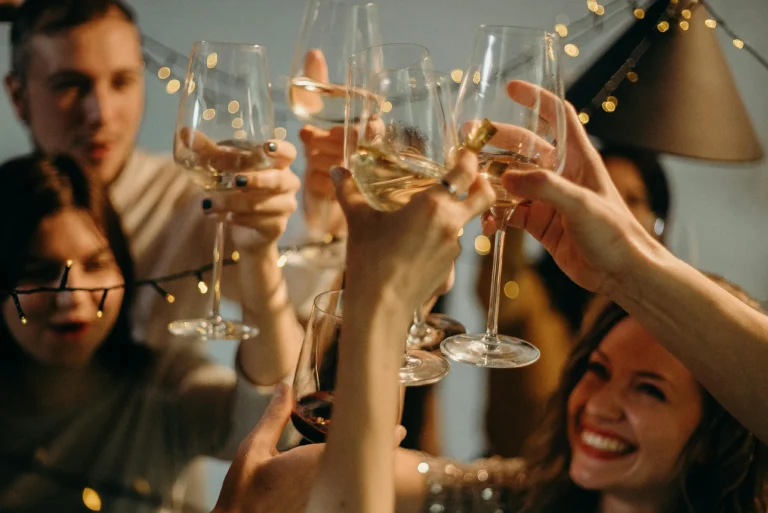 Hyper Real Academy PMU training celebration with students toasting wine glasses.