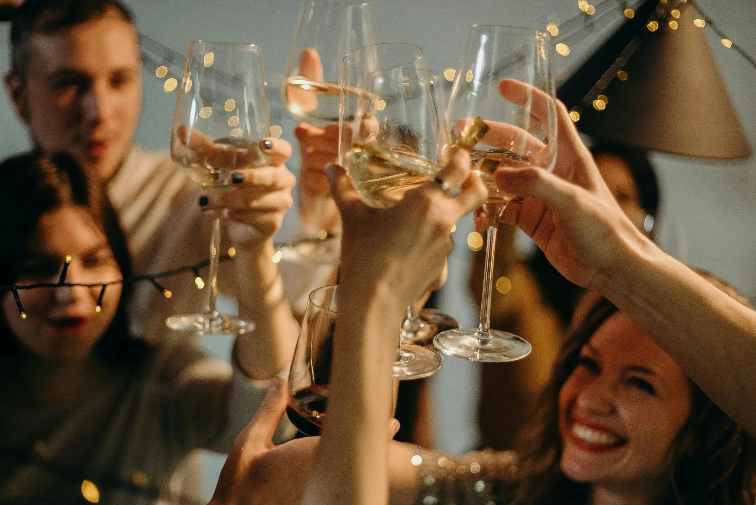 Hyper Real Academy PMU training celebration with students toasting wine glasses.