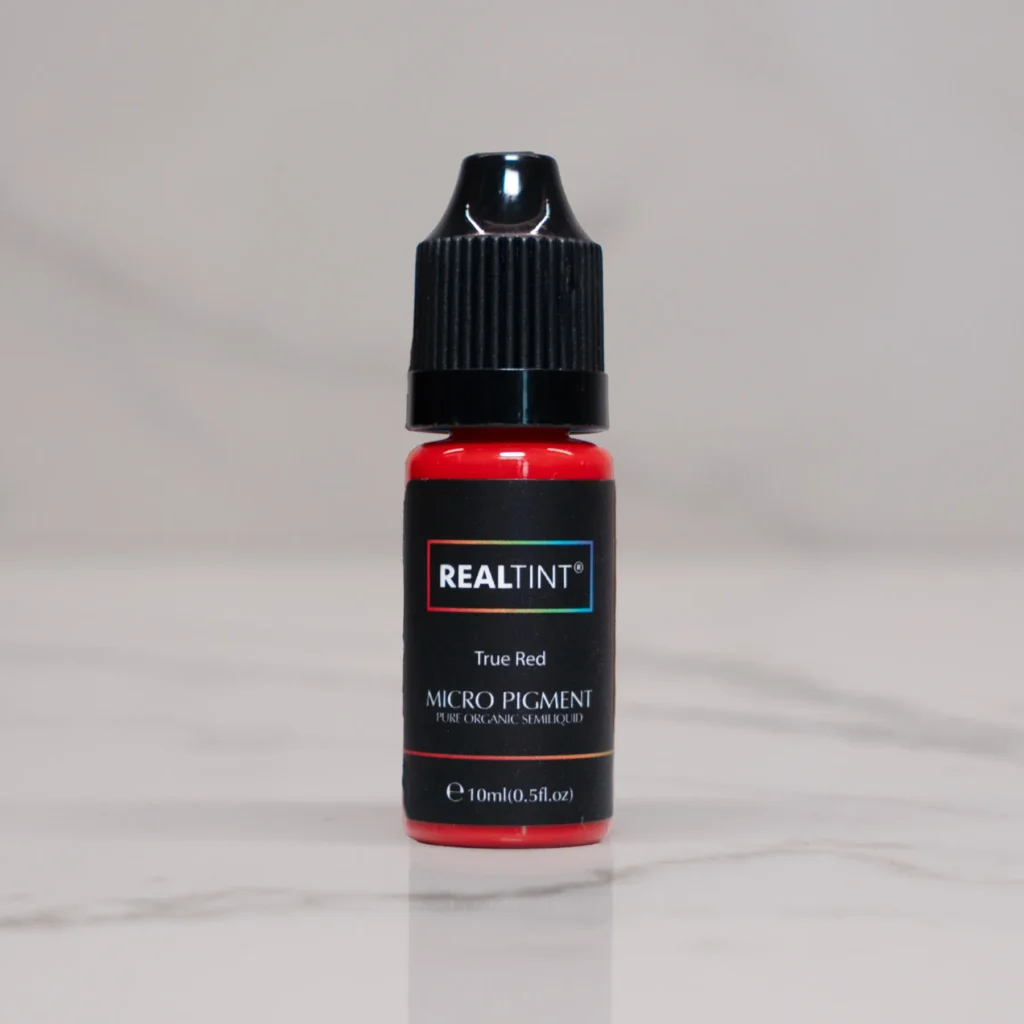 RealTint True Red micro pigment bottle for PMU training, lip blush, and eyeliner demonstration.