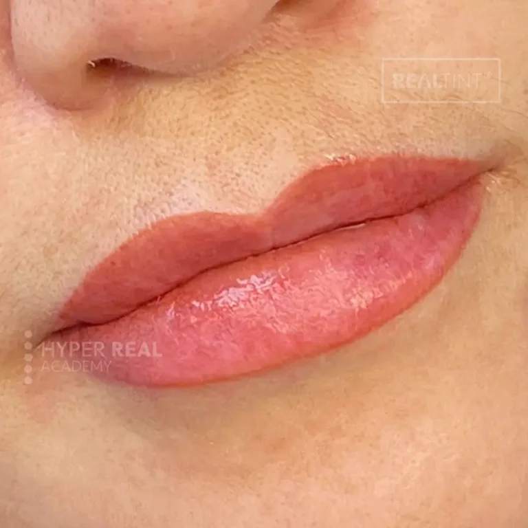 Powder brows and eyeliner PMU results. Soft, filled-in brows with powdered finish, thin black eyeliner along upper lash line. Natural makeup look with defined eyes. Hyper Real Academy style ombre brows and lash line enhancement.